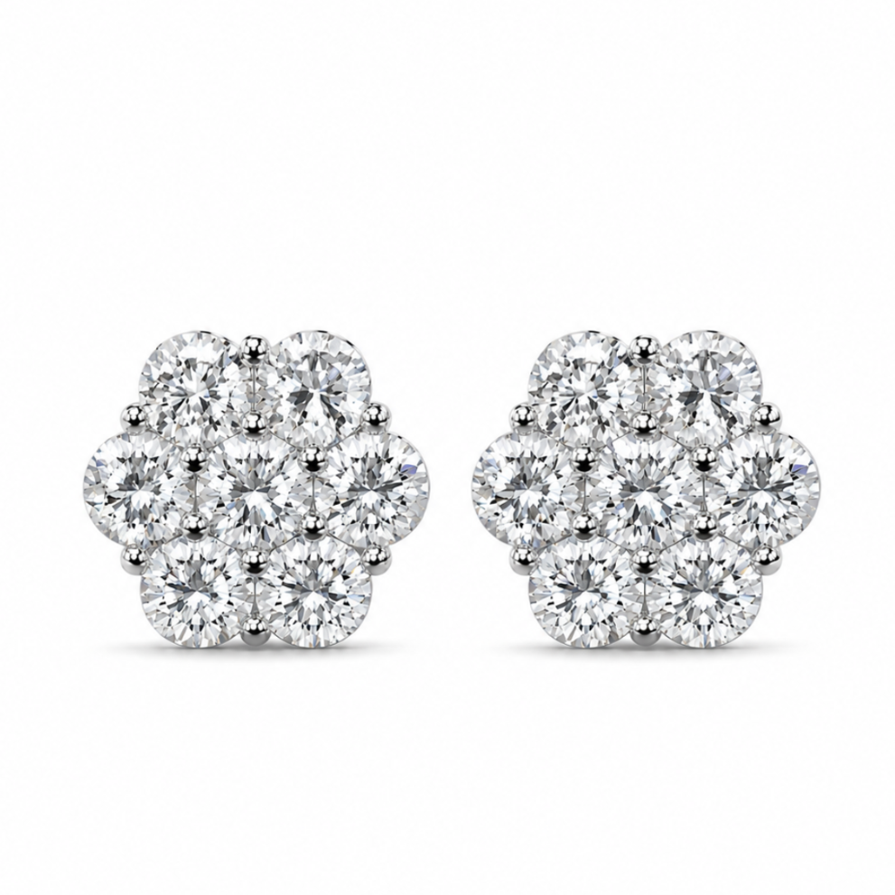 A pair of round cluster stud earrings made of silver-toned metal and set with clear gemstones, shown against a plain white background.