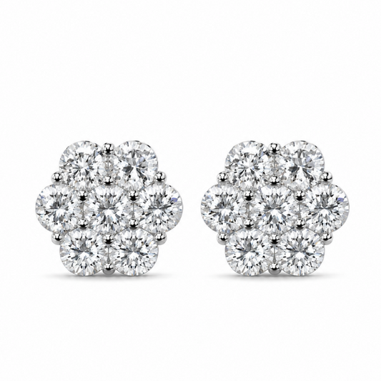 A pair of round cluster stud earrings made of silver-toned metal and set with clear gemstones, shown against a plain white background.